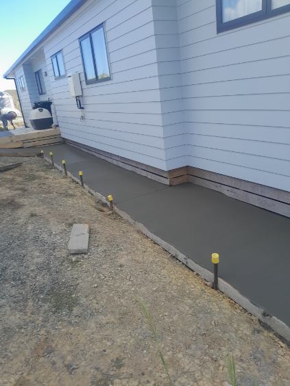 Decorative grey concrete steps leading to a front door